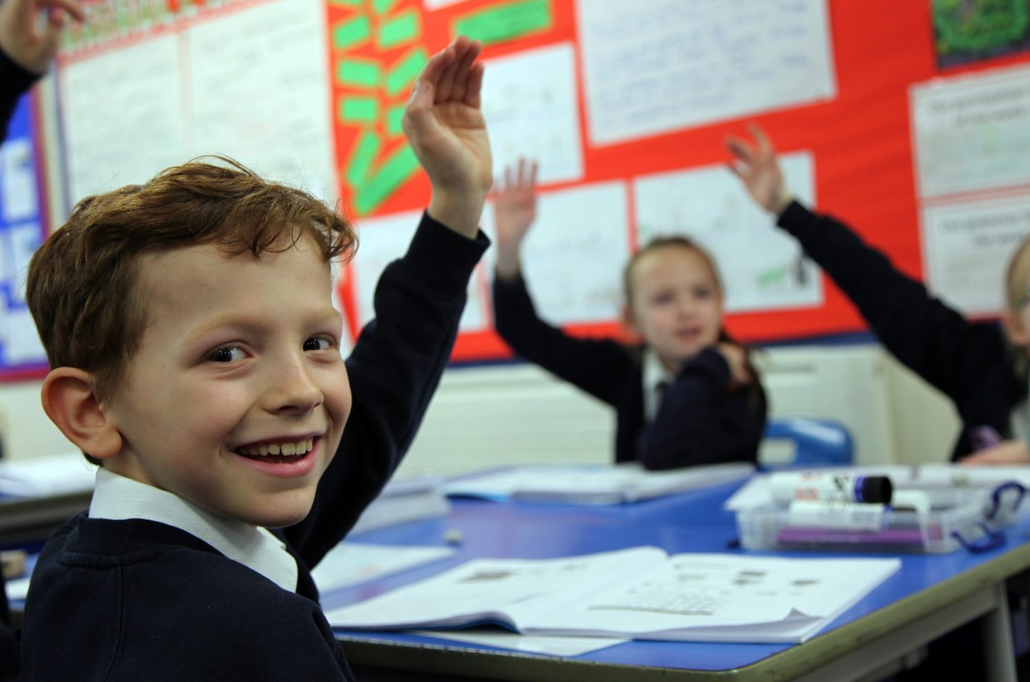 Children with their hands up